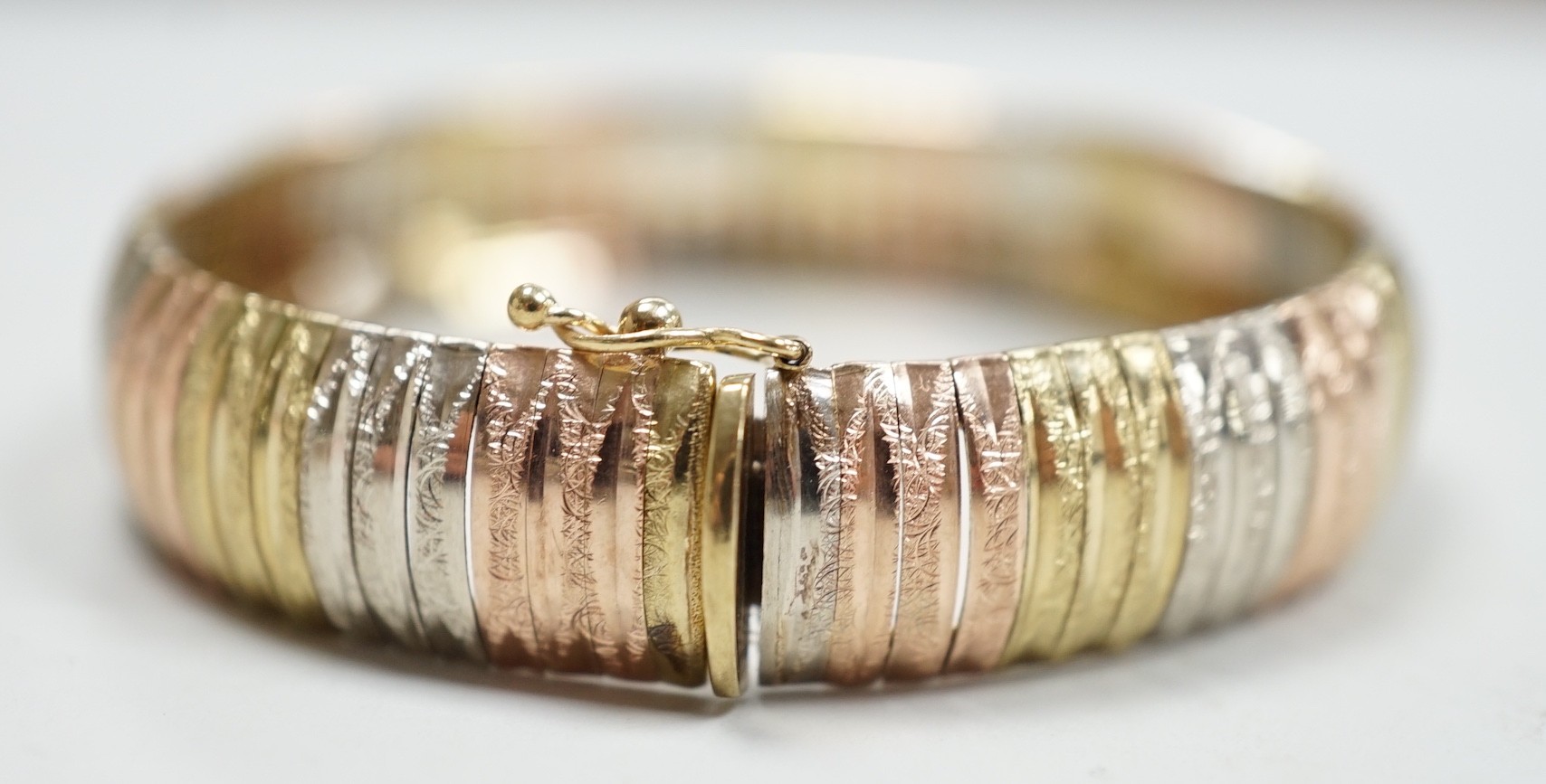 A modern Italian three colour 9ct gold bracelet, 18cm, 18 grams.